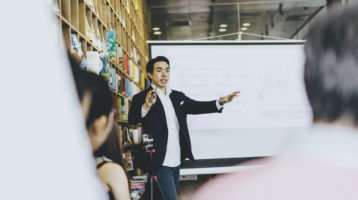 business man speaking to a crowd